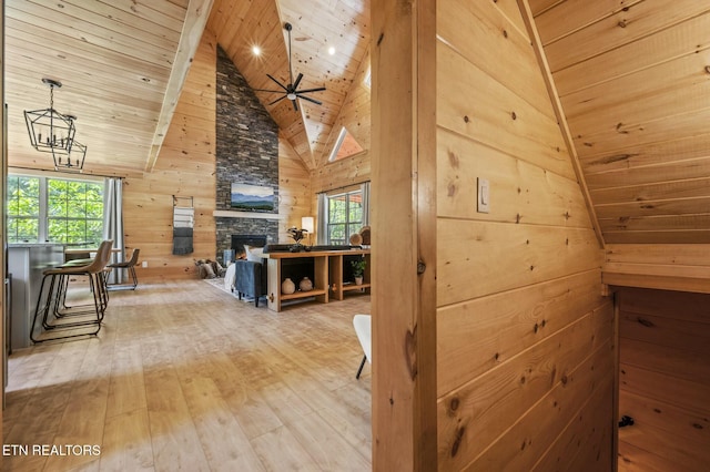 hallway with wood walls, plenty of natural light, and hardwood / wood-style flooring