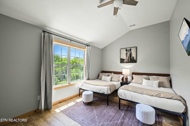 bedroom with ceiling fan, wood-type flooring, and lofted ceiling