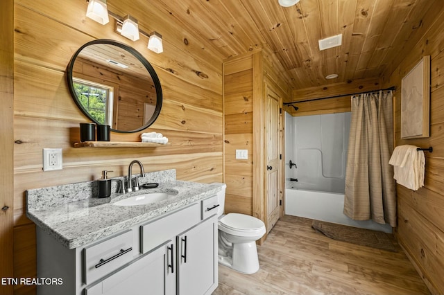 full bathroom featuring vanity, wood walls, hardwood / wood-style flooring, toilet, and shower / bathtub combination with curtain