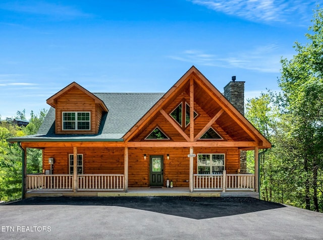 log-style house with a porch