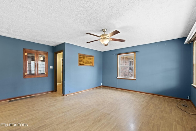 unfurnished room featuring ceiling fan, a textured ceiling, and light hardwood / wood-style flooring