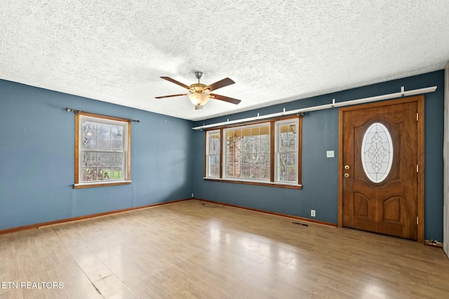 entryway with a wealth of natural light and light hardwood / wood-style flooring