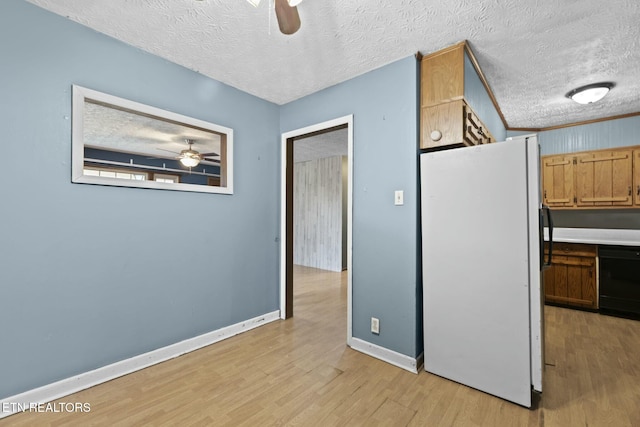 kitchen featuring ceiling fan, black dishwasher, white refrigerator, light hardwood / wood-style floors, and a textured ceiling