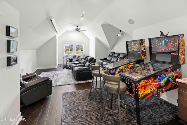 playroom with dark hardwood / wood-style floors, vaulted ceiling, and ceiling fan