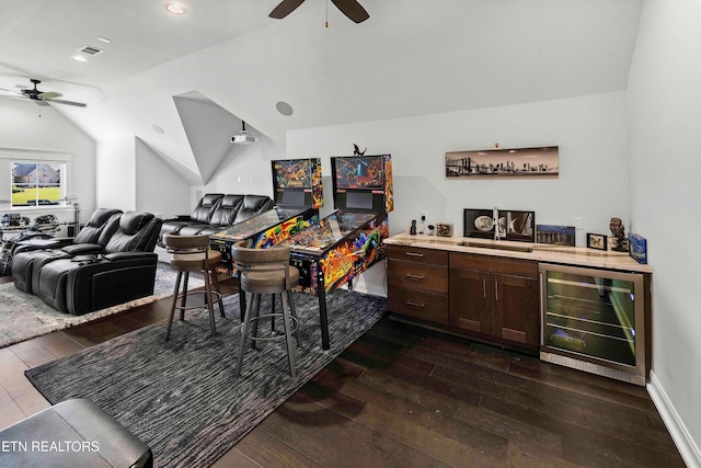 bar with dark brown cabinetry, vaulted ceiling, beverage cooler, dark wood-type flooring, and sink