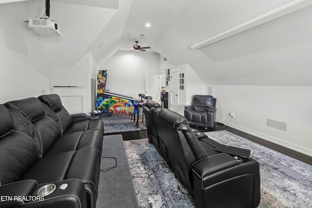 home theater room featuring ceiling fan, vaulted ceiling, and hardwood / wood-style flooring