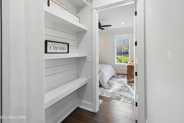 bedroom with ceiling fan, crown molding, and dark hardwood / wood-style floors