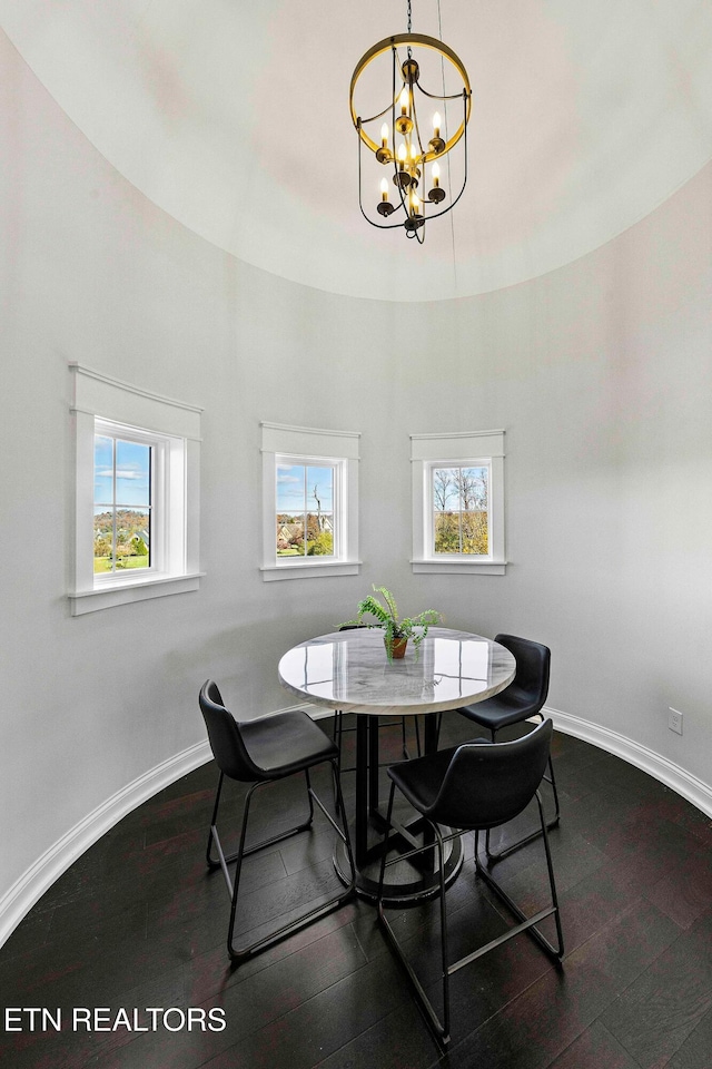 dining room featuring hardwood / wood-style flooring and an inviting chandelier