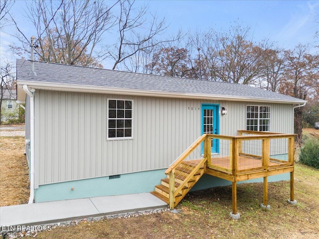 back of property with a wooden deck