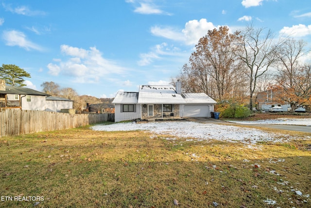 exterior space featuring a lawn and a garage