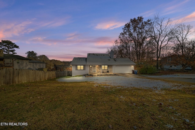 view of front facade with a garage and a yard