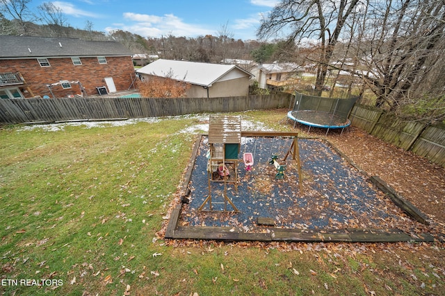 view of yard featuring a trampoline and a playground