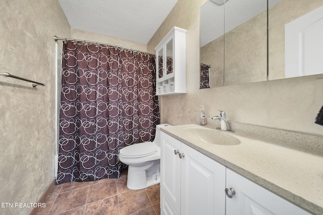 bathroom featuring vanity, a textured ceiling, and toilet