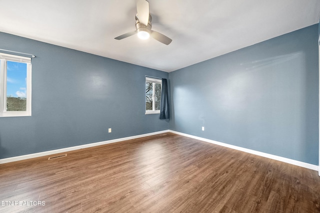 empty room featuring ceiling fan and hardwood / wood-style flooring