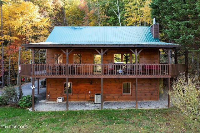 back of house featuring a patio, a yard, a deck, and central AC