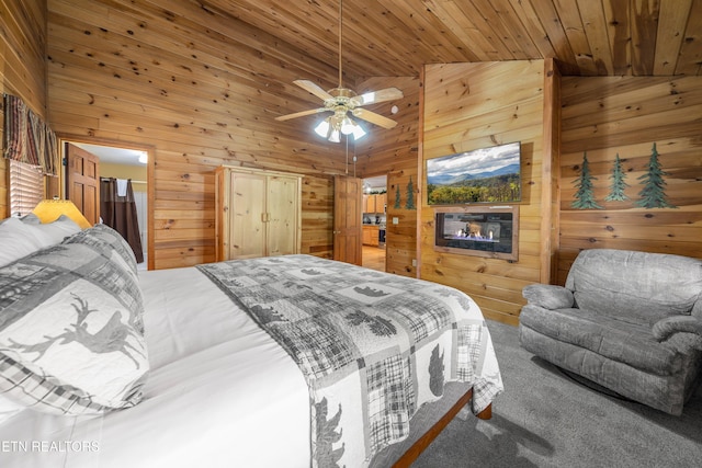 bedroom featuring ceiling fan, wooden ceiling, high vaulted ceiling, carpet floors, and wooden walls