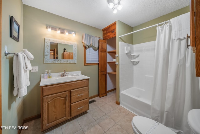 full bathroom with tile patterned floors, vanity, toilet, and a textured ceiling