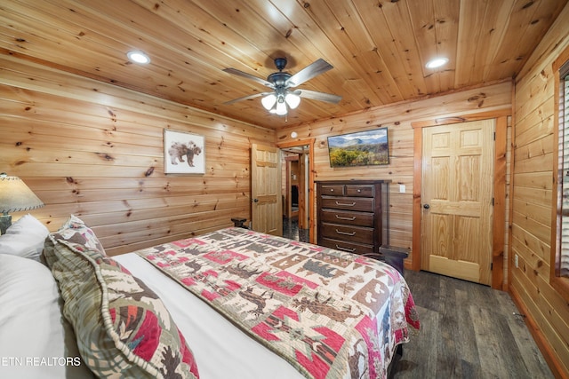 bedroom with wooden walls, ceiling fan, dark wood-type flooring, and wooden ceiling