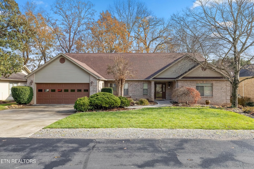 view of front of home with a front yard and a garage