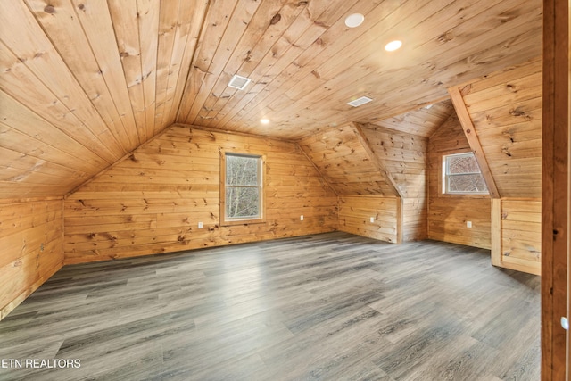 additional living space with dark hardwood / wood-style floors, wood walls, wooden ceiling, and vaulted ceiling