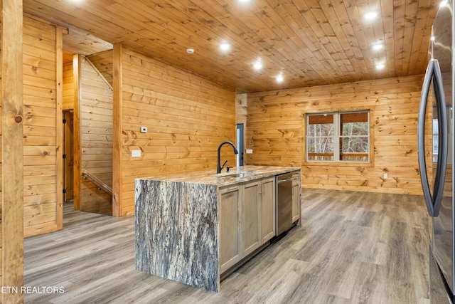 bar featuring stainless steel appliances, wood walls, light stone countertops, and light hardwood / wood-style floors