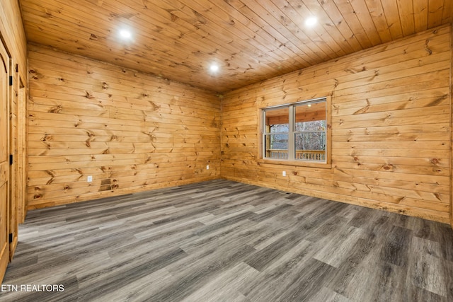 unfurnished room with hardwood / wood-style flooring, wooden ceiling, and wooden walls