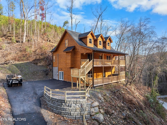 back of house featuring covered porch and a garage