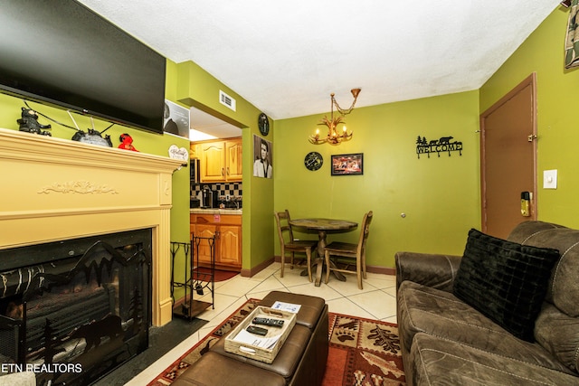 living room with light tile patterned flooring and a notable chandelier