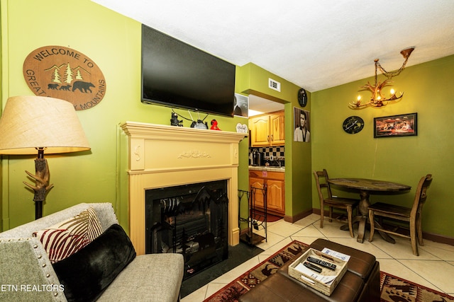 living room with a chandelier and light tile patterned floors