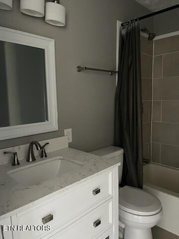 full bathroom featuring vanity, shower / bath combination with curtain, and toilet