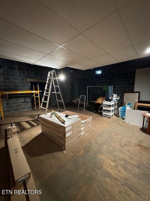 basement with a paneled ceiling