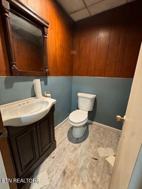 bathroom with vanity, a paneled ceiling, and toilet