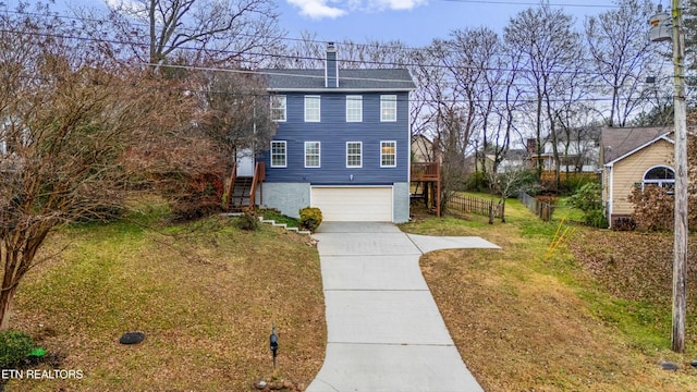 view of front of home with a garage and a front lawn