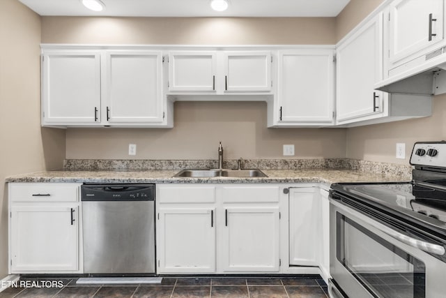 kitchen with appliances with stainless steel finishes, ventilation hood, white cabinetry, and sink