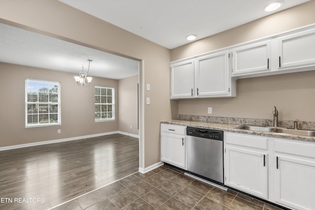 kitchen with dishwasher, dark wood-type flooring, white cabinets, sink, and a notable chandelier