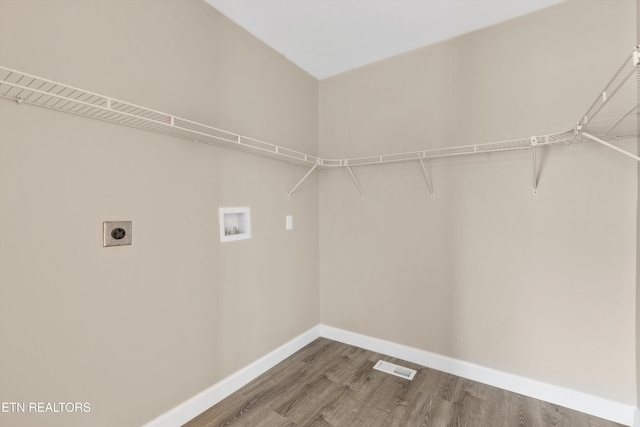 washroom with washer hookup, wood-type flooring, and electric dryer hookup