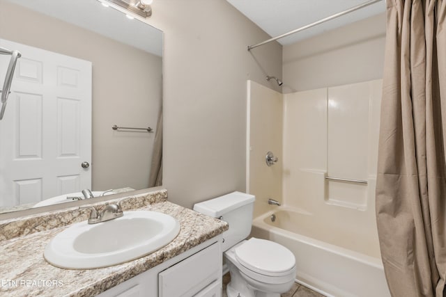 full bathroom featuring tile patterned floors, shower / bath combo with shower curtain, vanity, and toilet