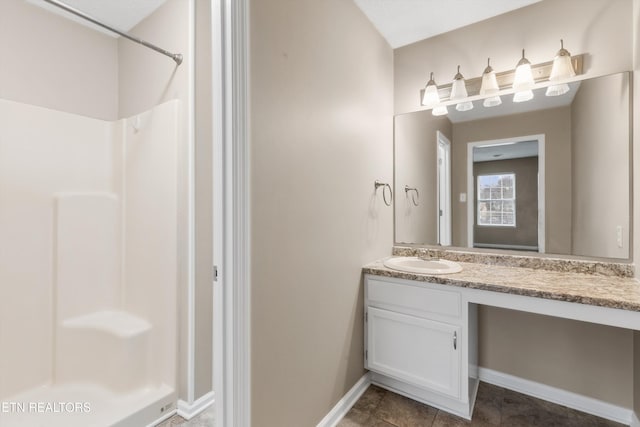 bathroom featuring tile patterned floors, vanity, and walk in shower