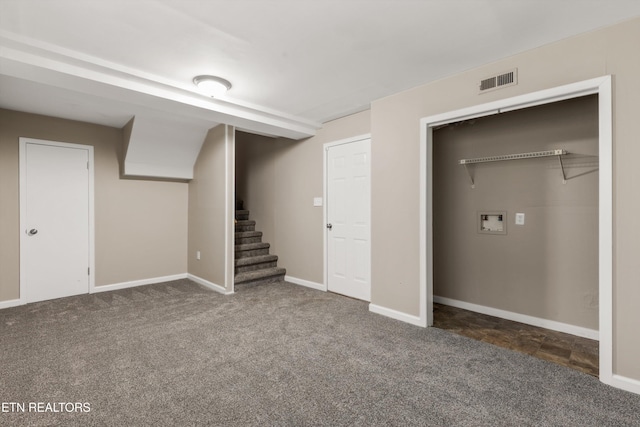 basement featuring dark carpet