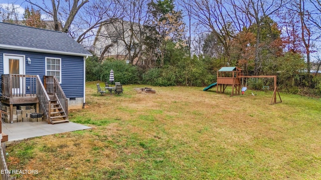 view of yard with a playground and an outdoor fire pit