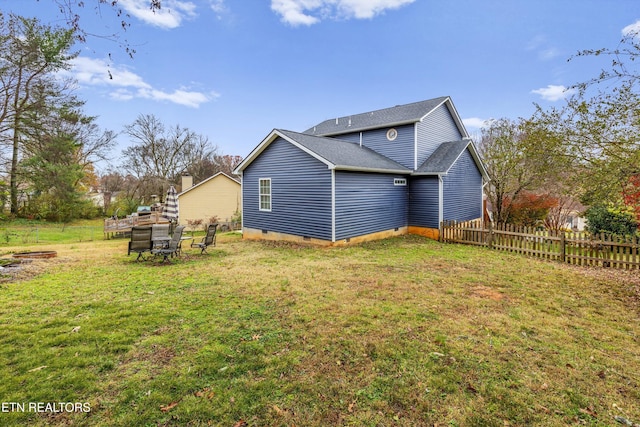 view of side of home featuring a lawn