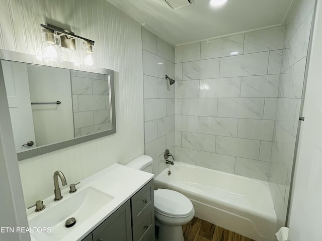 full bathroom with toilet, vanity, tiled shower / bath combo, and hardwood / wood-style flooring