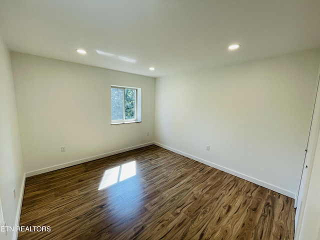 spare room with dark hardwood / wood-style floors