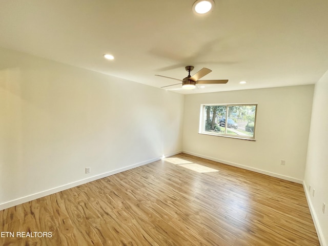 unfurnished room featuring ceiling fan and light wood-type flooring