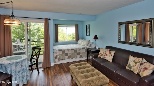 bedroom with a textured ceiling and dark wood-type flooring