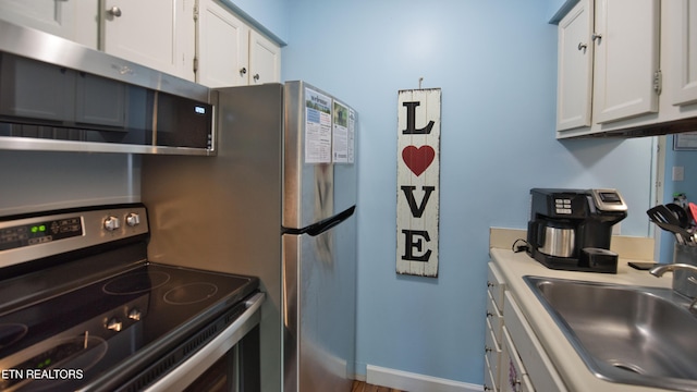 kitchen featuring white cabinetry, sink, and appliances with stainless steel finishes