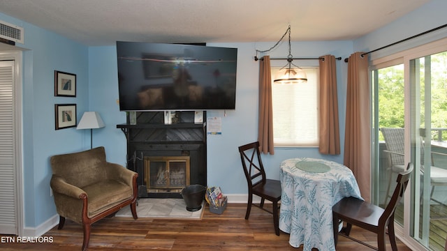 dining space featuring dark hardwood / wood-style flooring and a textured ceiling