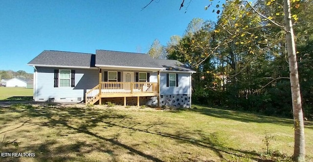 rear view of house with a wooden deck and a lawn