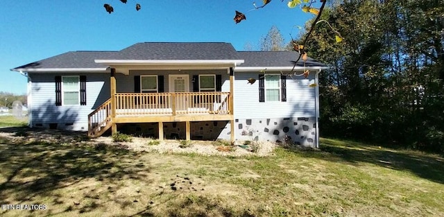 rear view of property featuring a lawn