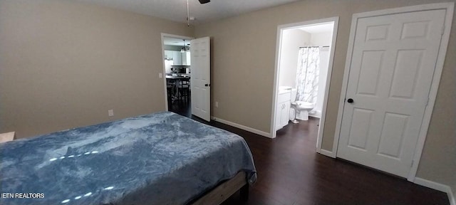 bedroom with ensuite bathroom, ceiling fan, and dark wood-type flooring